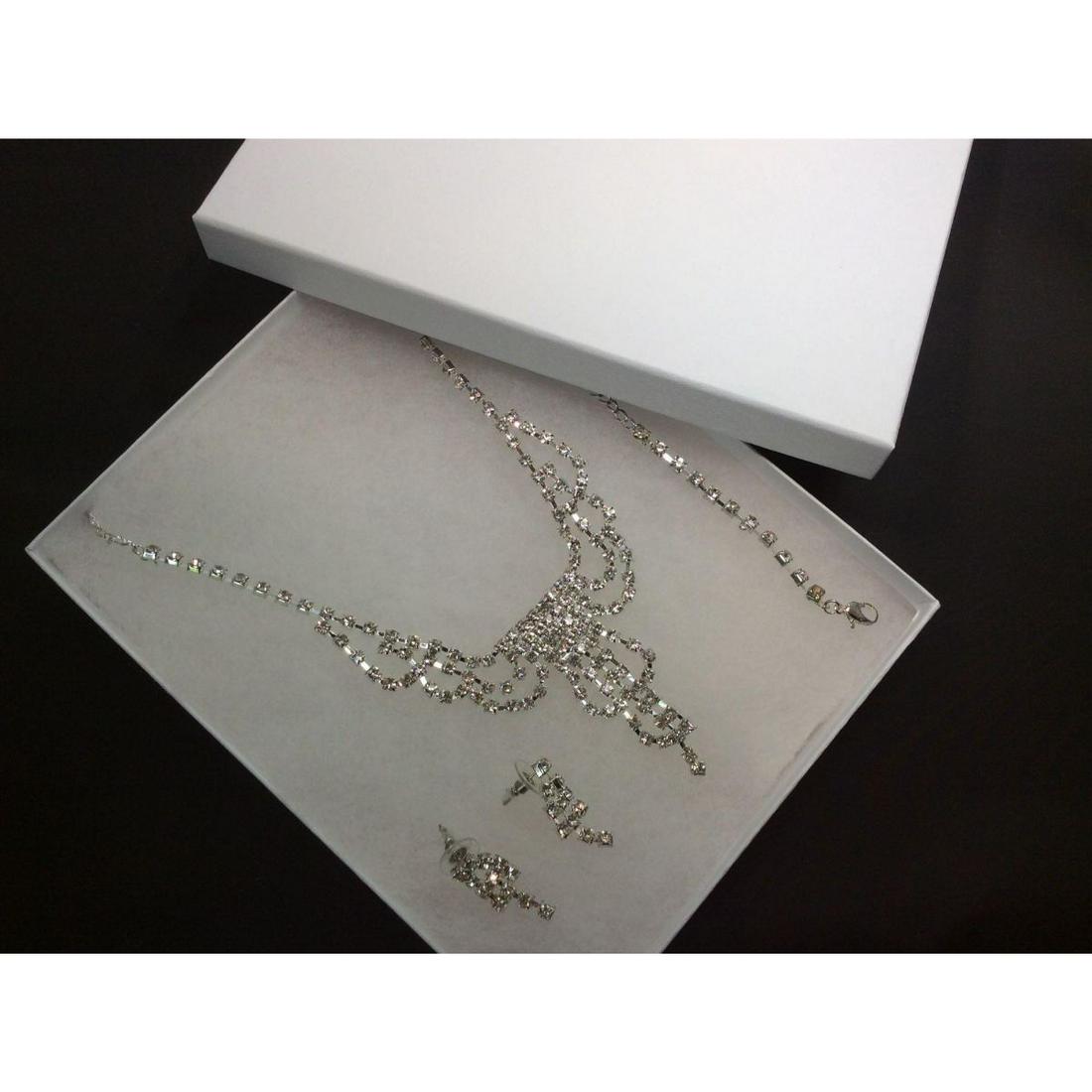Czech Crystal Rhinestone Bridal Necklace Set: Perfect for a multitude of formal occasions from weddings to formal dances or events, this rhinestone crystal set is sure to dazzle. Complete with matching earrings and bracelet to complement the stun