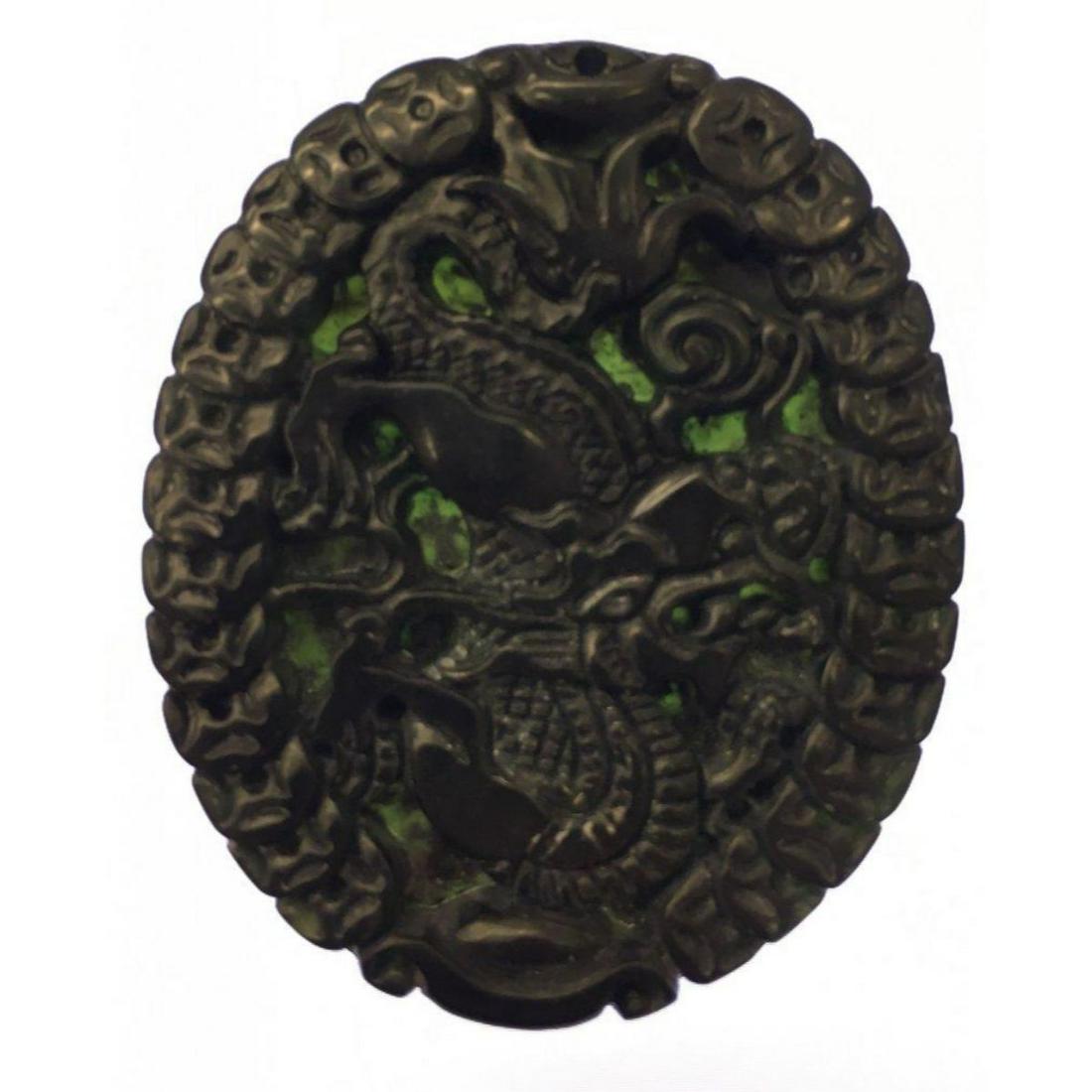 Asian Green Jade Carved Dragon Medallion: An Asian Green/Black Jade Carved Dragon Medallion. In Chinese Culture The Dragon Symbolizes Strength and Power. Black jade represents power, protection, wisdom and self-control. In a broader sense, th