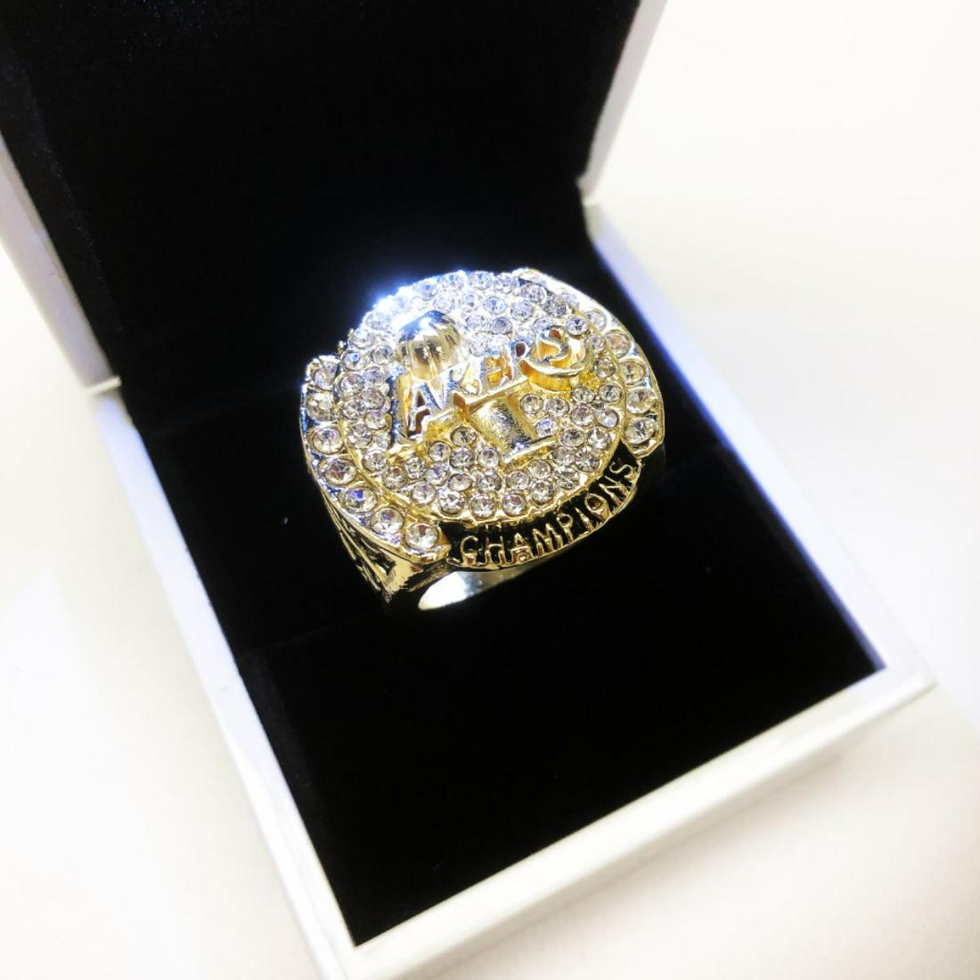 2009 LA Lakers Kobe Bryant NBA Championship Ring: 2009 LA Lakers Kobe Bryant NBA Championship Ring. A Perfect Replica Crafted With Gold Gilt And Semi Precious Stones. The late Kobe Bryant was true pillar of the basketball being considered one of the