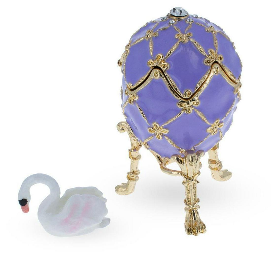 1906 The Swan Royal Russian Egg: 1906 The Swan Royal Russian Egg 2.8 Inches Tall (on a stand) x 1.65 Inches Wide 7.112 cm Tall (on a stand) x 4.191 cm Wide Enameled Gold Plated Pewter Hand Painted Gift Boxed This hand-painted sparkli