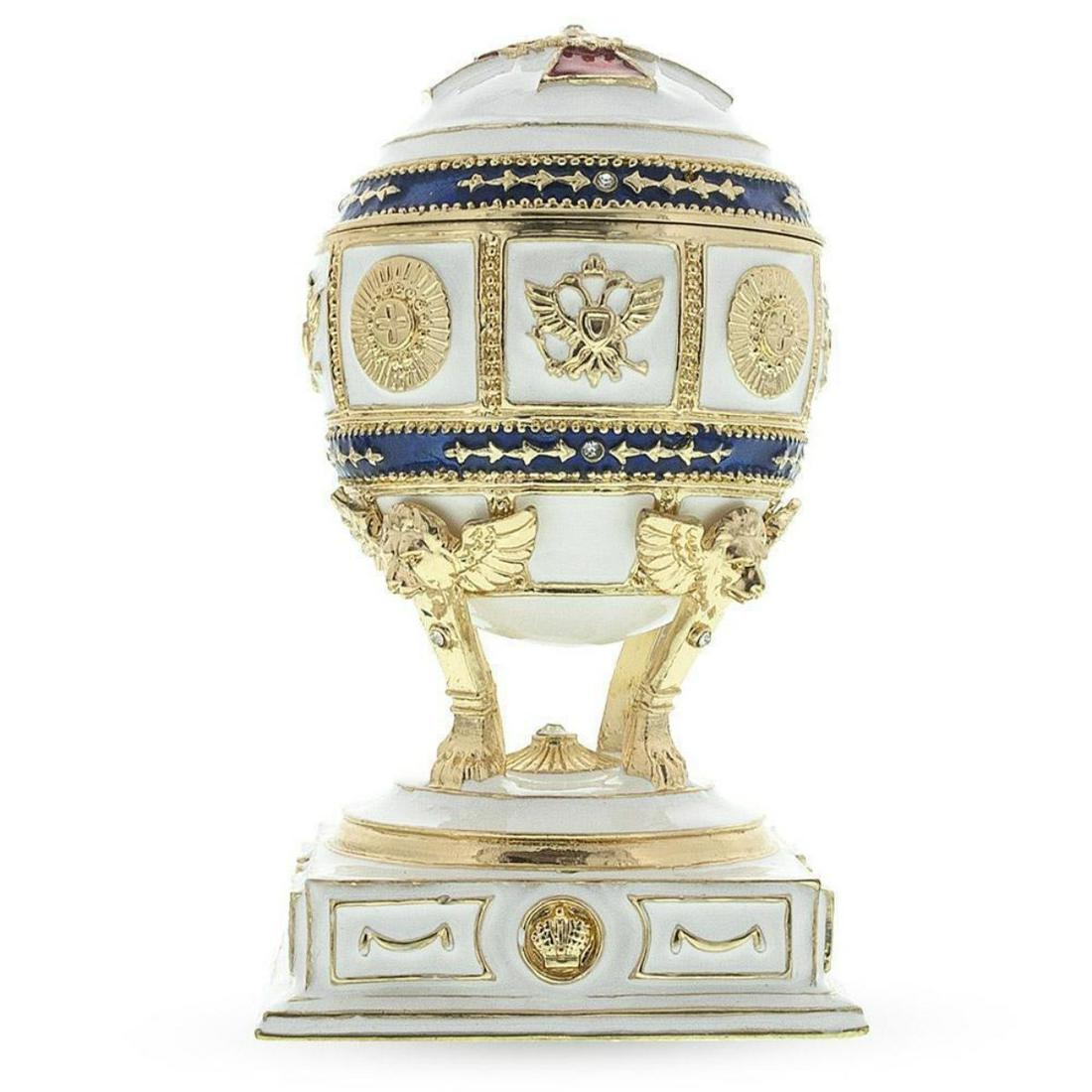 Red Cross on White Enamel Royal Inspired Russian Egg: Red Cross on White Enamel Royal Inspired Russian Egg 4.5 Inches Tall (on a stand) x 3.6 Inches Wide 11.43 cm Tall (on a stand) x 9.144 cm Wide Enameled Gold Plated Pewter Hand Painted This hand-painte
