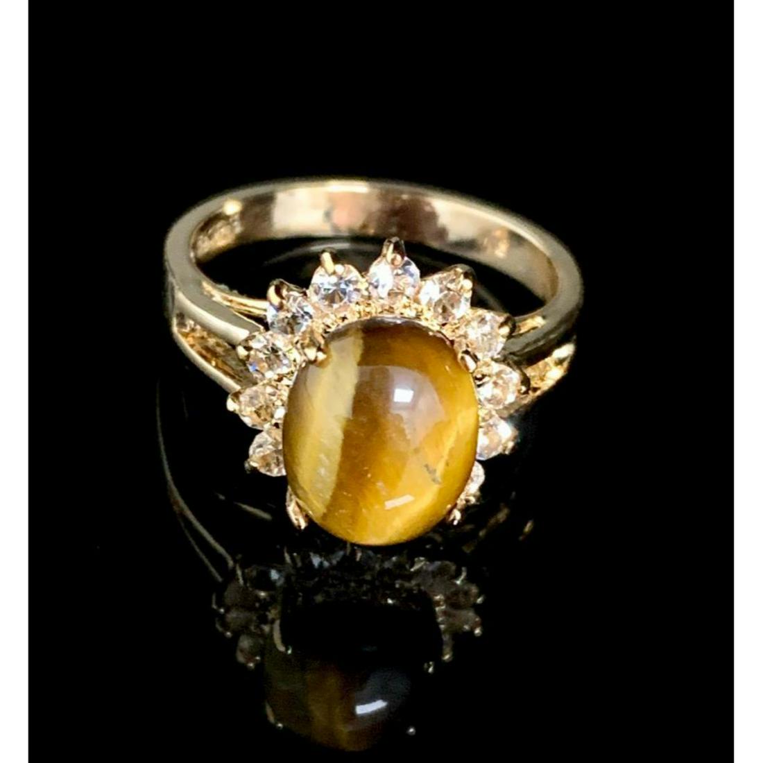 Dolphin Ore Size 7 3ct Oval Cut Tigers Eye in 18K Gold: Dolphin Ore Size 7 3ct Oval Cut Tigers Eye in 18K Gold Plated Ring. Please view photos for further details.