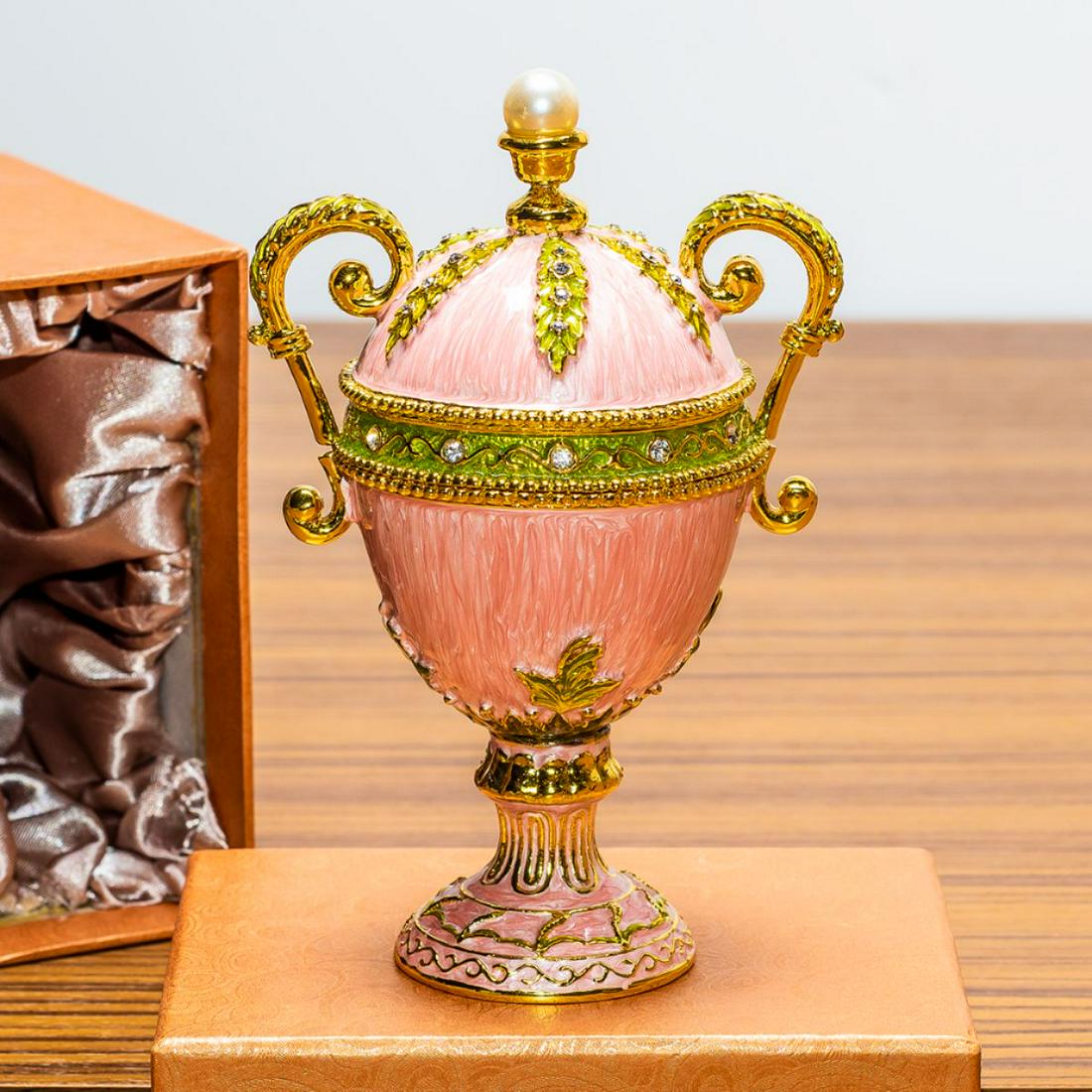 5.5â€ Pink Amphora Enameled Royal Inspired Russian Egg: Youâ€™ll love the elegance of this pink-hued Royal inspired Russian Easter egg. A display stand attached to this beauty. Fashioned from fine pewter. Then it is hand enameled by skilled artisans. 