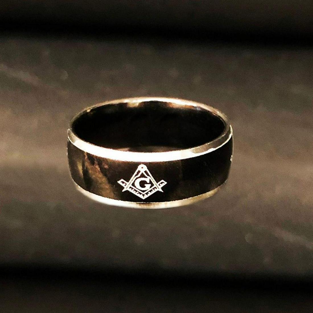 Black Mens Titanium Engagement Ring Size 10: A Black Titanium Mens Engineers Ring with Insignia On The Front Of The Ring. Ring Is Size 10 And Is In great Condition. View Photos For Further Details.