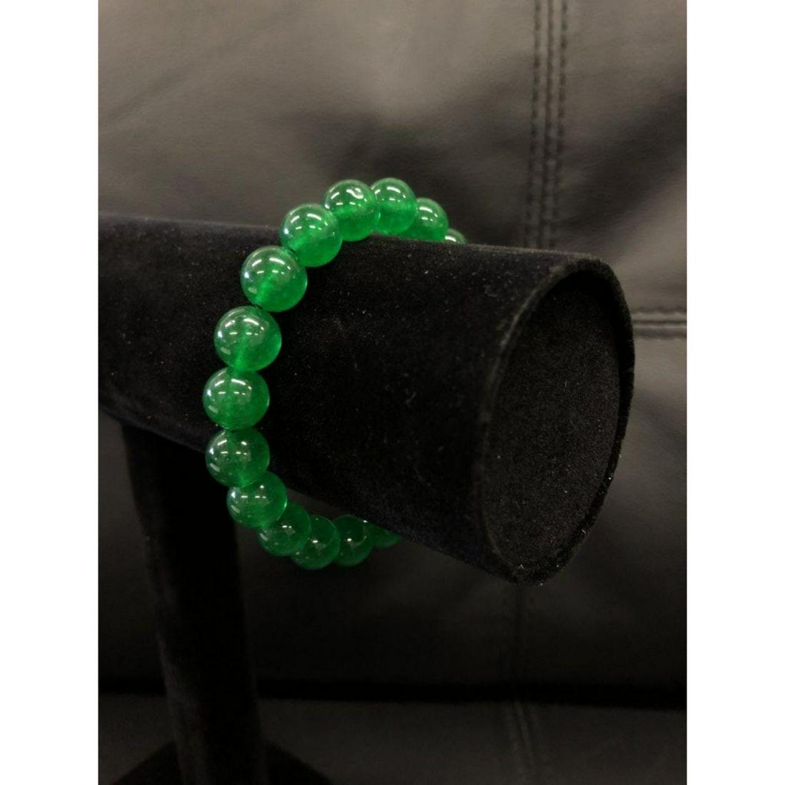 This beautifully crafted Asian Green Jade Beaded: This beautifully crafted Asian Green Jade Beaded Bracelet holds 20 lusterous Jade beads, and is a staple in Chinese jewelry as their culture values the artwork and craftsmanship of Jade pieces. See ph