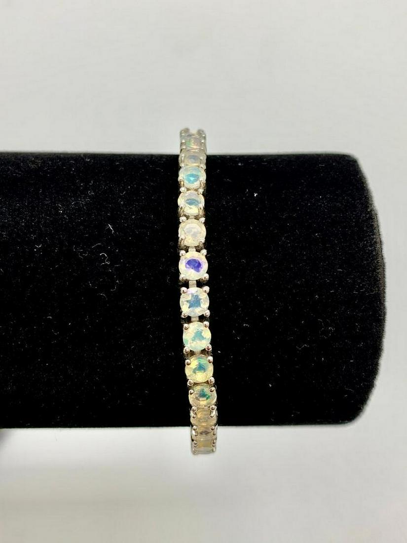 11ct Multi-colored Round Cut Cubic Zerconia Bracelet set in 925 Silver: 11ct Multi-colored Round Cut Cubic Zerconia Bracelet set in 925 Silver. The bracelet contains a total of 37 stones, each at a carat weight of .3. Please view photos for further details.