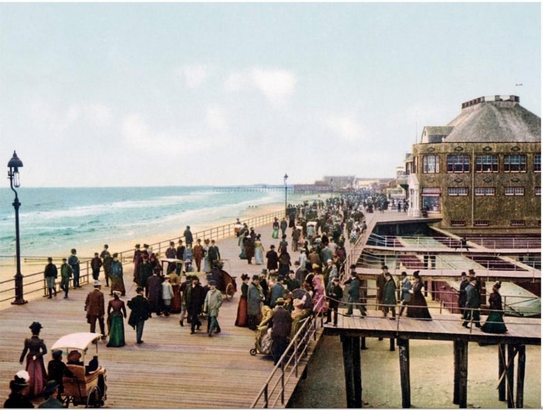 Photograph of The Atlantic City Board Walk in New Jersey Print by the Henry Ford Museum: Photograph of The Atlantic City Board Walk in New Jersey Print by the Henry Ford Museum. Old photograph of well-dressed people walking along the Atlantic City Boardwalk in New Jersey. Seaside building