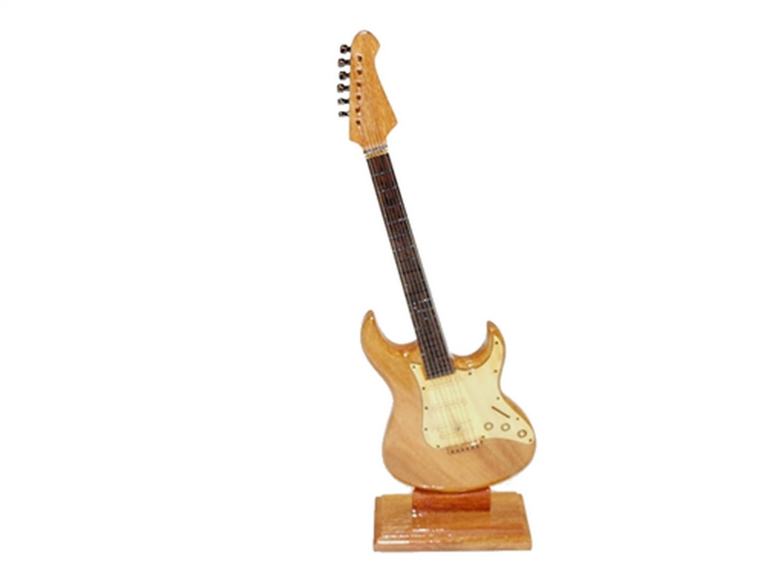 Electric Guitar: Electric Guitar This electric guitar is hand crafted from solid Mahogany and would make a perfect gift for any musician. Dimensions: 12" tall x 4" wide View photos for further details.