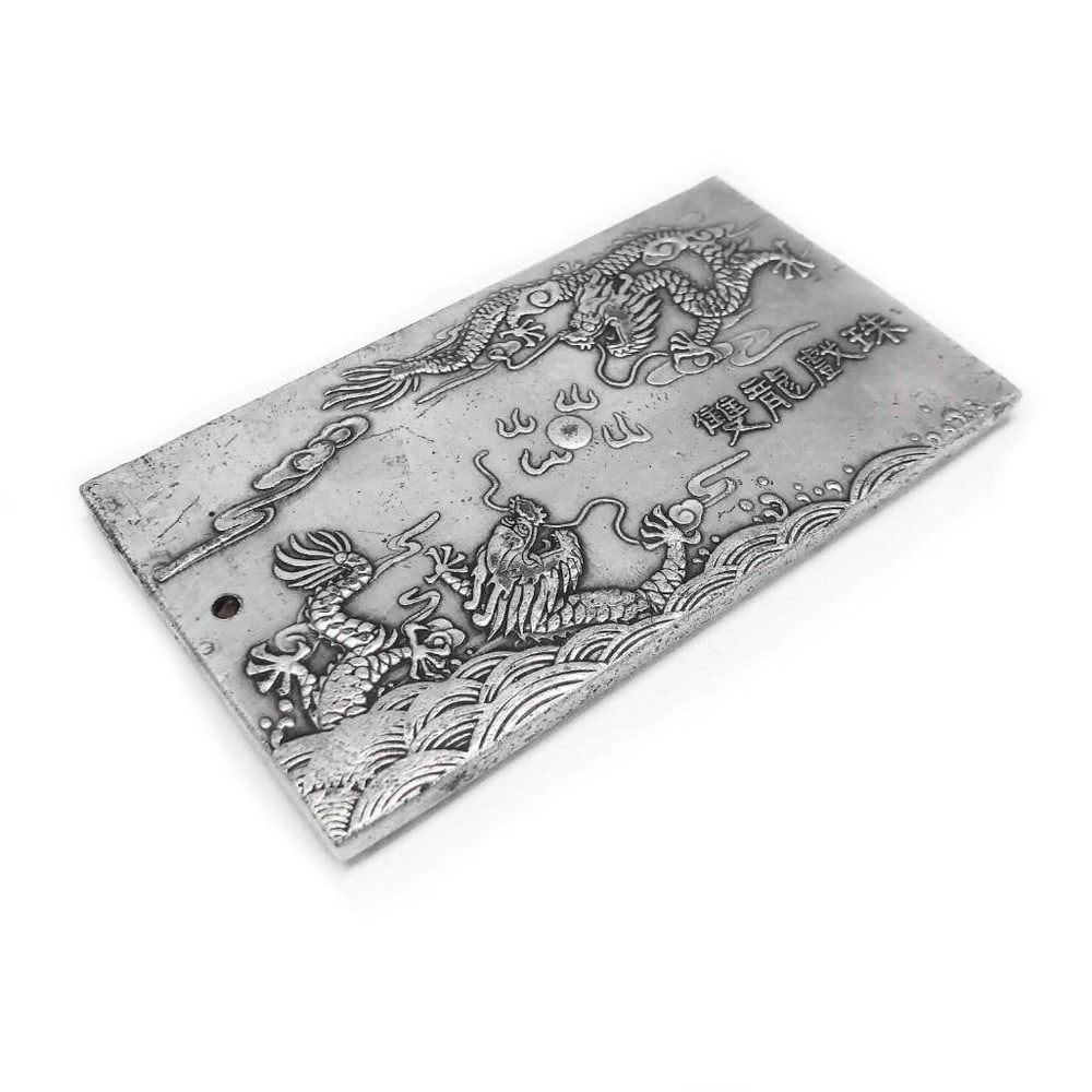 Tibetan Silver Bullion Amulet Bar Depicting the Fuzanglong Dragons: Tibetan Silver Bullion Amulet Bar Depicting the Fuzanglong Dragons. This captivating Tibetan silver bullion amulet bar features an intricate depiction of the Fuzanglong dragons, mythical creatures rev