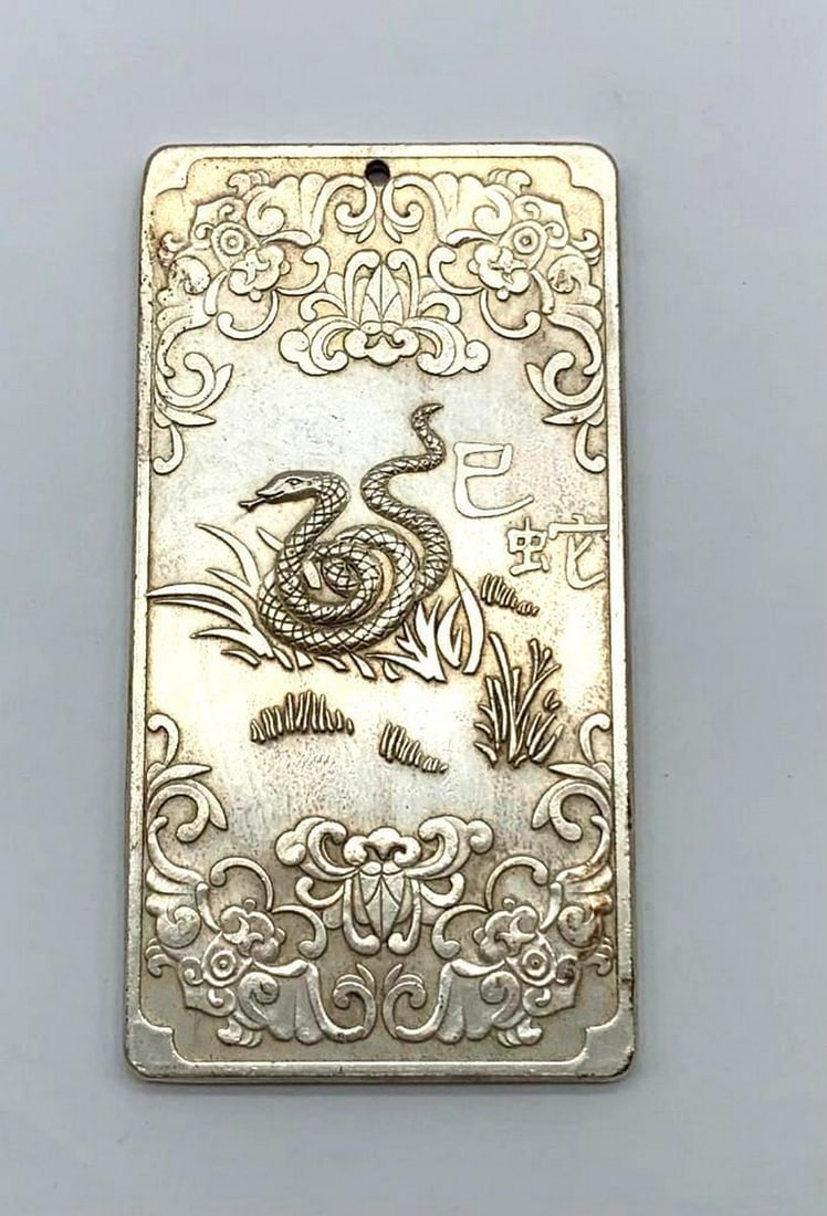 Tibetan Silver Amulet Bar Depicting The Year Of The Snake: Tibetan silver amulet bar depicting the year of the Snake. This amulet bar is one of the 12 Tibetan astrology years in the 12 piece series. Weighing 130g, 9.5cm in Length, 5cm in Width, 3mm in Thickne
