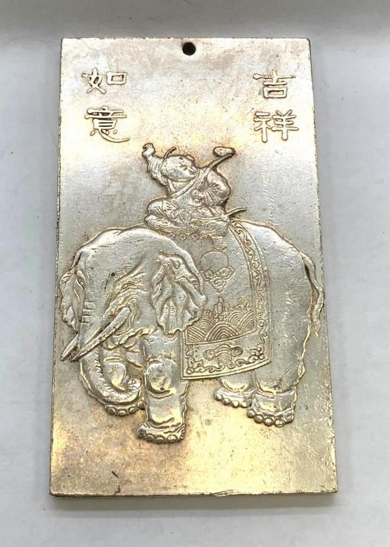Tibetan Silver Bullion Bar Featuring The Elephant and Flying Monk: Tibetan Silver Bullion Bar Featuring The Elephant and Flying Monk. Elephants are held in high regard in Buddhist culture and symbolize qualities such as wisdom, strength and perceptiveness. Buddhists 