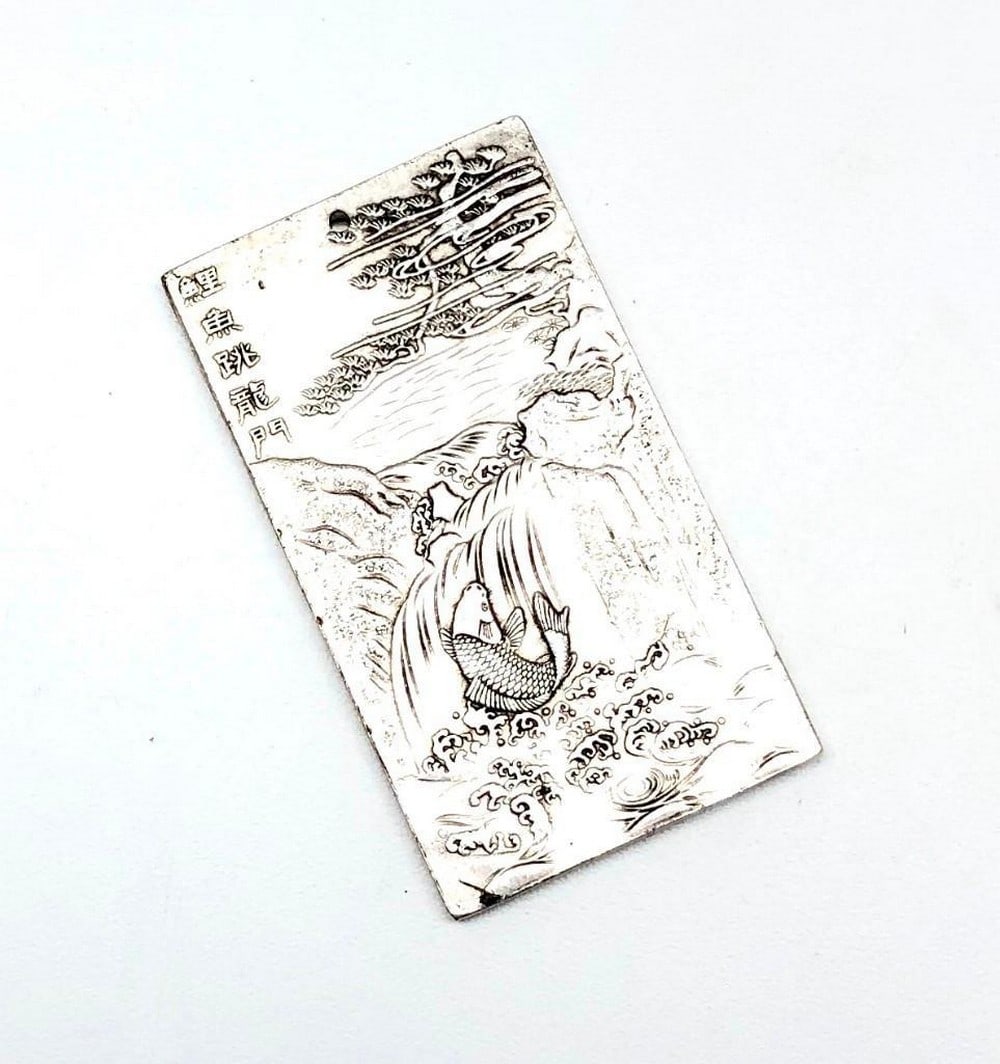 Tibetan Silver Bullion Bar Depicting a Surfacing Koi Fish Swimming Up Stream: Tibetan Silver Bullion Bar Depicting a Surfacing Koi Fish Swimming Up Stream.Â This captivating Tibetan silver bullion bar depicts a beautifully rendered koi fish surfacing as it swims upstream, sym