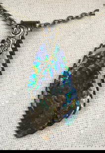 Midnight Umber Ammolite Pendant: Midnight Umber Ammolite Pendant This ammolite pendant features a gem in deep blue and umber, with occasional brighter flecks. The stone has a more subdued, earthy appearance, making it an ideal choic