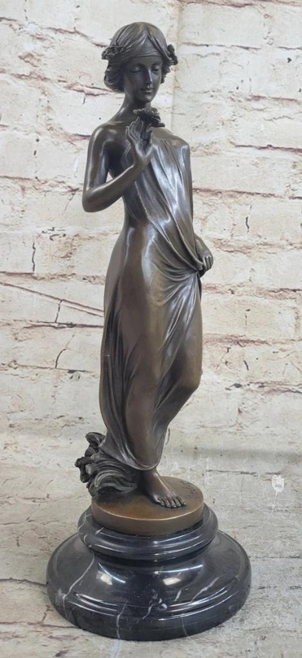 Women Balancing Flower on Finger Original Bronze Statue - 13.5" x 5": Women Balancing Flower on Finger Original Bronze Statue - 13.5" x 5" This captivating bronze sculpture transports us to a serene moment of contemplation. The young lady, elegantly poised, gaze