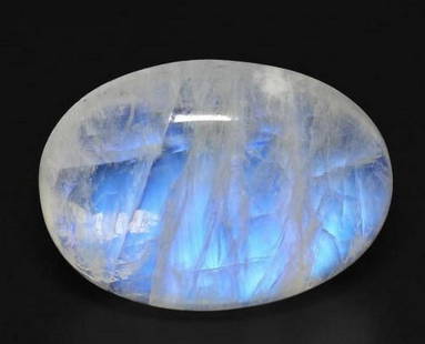 17.7ct Oval Cabochon Bluish White Loose Rainbow Moonstone: 17.7ct Oval Cabochon Bluish White Loose Rainbow Moonstone A mesmerizing 17.7ct oval cabochon rainbow moonstone with a luminous bluish-white glow. This captivating gem showcases a shimmering adularesce
