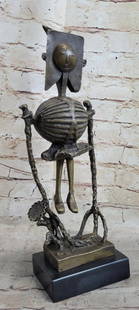 Robot Skeleton Bronze Statue Sculpture: Robot Skeleton Bronze Statue Sculpture  This abstract sculpture is a great conversation piece. There is profile of a person is smoothly carved onto a stone rock. The contradicting style of the smooth,