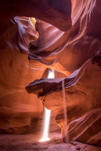The Stillness Between: The Stillness Between  A breathtaking play of shadow and sunlight dances across the sculpted sandstone walls of Antelope Canyon. Carved by wind and water over millennia, the narrow passage glows with