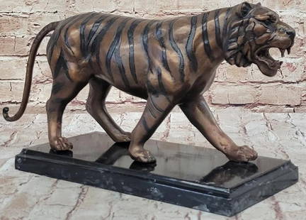 Reproduction Bronze Tiger Sculpture: Reproduction Bronze Tiger Sculpture   This impressive reproduction bronze sculpture pays homage to the majestic beauty of the tiger, bearing the signature of celebrated artist Jules Moigniez. The tige