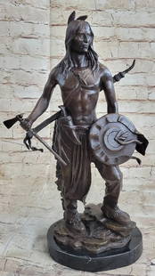 Bronze Sculpture of a Native American Warrior With Tomahawk: Bronze Sculpture of a Native American Warrior With Tomahawk.  This striking bronze sculpture captures the fierce spirit and unwavering strength of a Native American warrior, poised with a tomahawk in