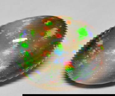 22.5ct Oval Cut Cabochon Bright Iridescence Multicolor Black Opal Gemstone: 22.5ct Oval Cut Cabochon Bright Iridescence Multicolor Black Opal Gemstone  Introducing our extraordinary 22.5ct Oval Cut Cabochon Bright Iridescence Multicolor Black Opal Gemstone – a mesmerizing k