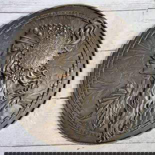 Elegant Muse – Bronze Medallion by Milo - 12" x 12": Elegant Muse – Bronze Medallion by Milo - 12" x 12" This exquisite bronze medallion captures the graceful profile of a captivating woman, her flowing hair cascading past her shoulders benea