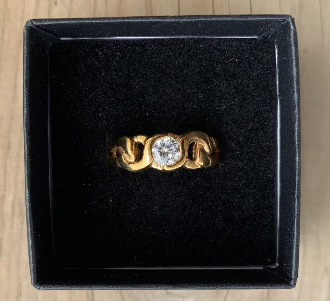 Regal Gold Solitaire Moissanite Ring: Regal Gold Solitaire Moissanite Ring This breathtaking ring showcases a brilliant round-cut moissanite set in a gleaming gold band. The prong setting elevates the gemstone, allowing exceptional light 