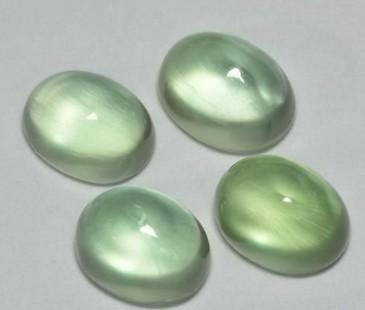 4.80ct Meadow Glow Prehnite: 4.80ct Meadow Glow Prehnite These 4.80ct natural prehnite gemstones feature a soothing warm green hue and excellent transparency, cut in elegant oval shapes. The gentle glow and serene color evoke a