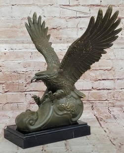 Soaring Majesty: Bronze Eagle with Wings and Claws Outstretched: Soaring Majesty: Bronze Eagle with Wings and Claws Outstretched  This dynamic bronze statue powerfully captures an eagle in full flight, wings spread wide and claws reaching forward as if about to gra