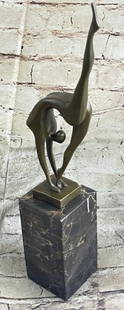 Abstract Bronze Ballerina in Motion: Abstract Bronze Ballerina in Motion  This sculpture captures a moment of breathtaking flexibility and poise in this abstract bronze ballerina sculpture. Balancing delicately on one foot, the dancer be