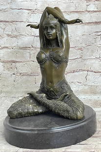 Costumed Dancer Bronze Sculpture: Costumed Dancer Bronze Sculpture  True to the Art Deco period, the lovely dancer in a remarkably decorated costume, sits indian-style with her arms bending behind her head in synchronicity. She sits h