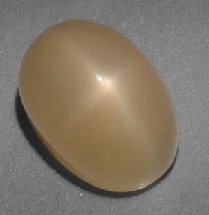 Loose Star Moonstone: Loose Star Moonstone  This enchanting loose Star Moonstone features a warm golden hue and a smooth oval cabochon shape, beautifully highlighting its natural asterism. When viewed under direct light, a