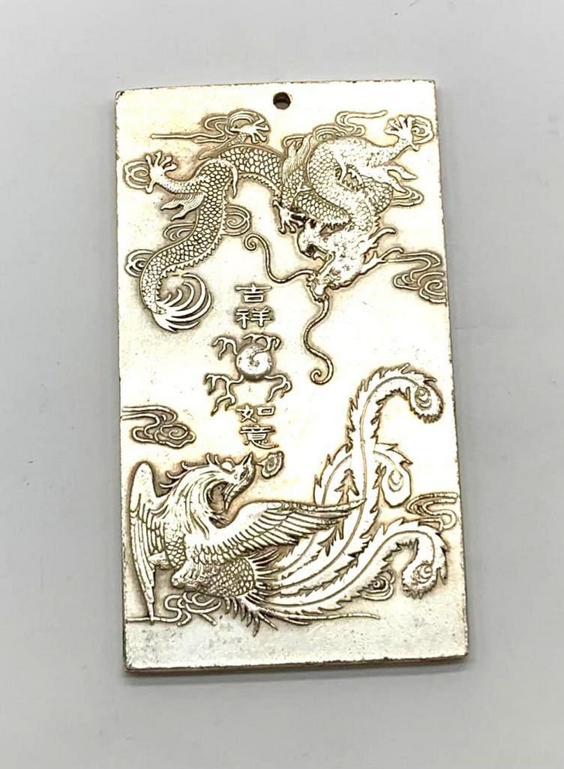Tibetan Silver Amulet Bullion Bar Showcasing The Dragon & The Phoenix: Tibetan Silver Amulet Bullion Bar Showcasing The Dragon and The Phoenix. The Dragon and the Phoenix frequently portrayed together in Chinese art, particularly in traditional wedding ceremonies and dec