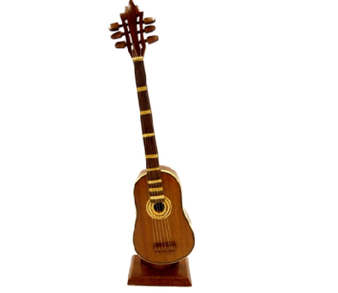 Classic Acoustic Guitar: Classic Acoustic Guitar This classic acoustic guitar is hand crafted from solid Mahogany and would make a perfect gift for any musician. Dimensions: 12" tall x 3.5" wide View photos for furthe