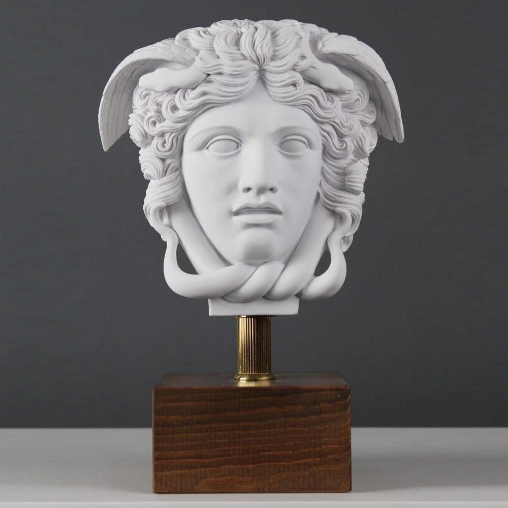 Stone Gaze Gorgon Medusa Head Sculpture on Base - (6lbs): Stone Gaze Gorgon Medusa Head Sculpture on Base - (6lbs) Introducing our Stone Gaze Gorgon Medusa Head Sculpture on Base—a captivating and substantial masterpiece weighing 6 pounds. This sculpture v