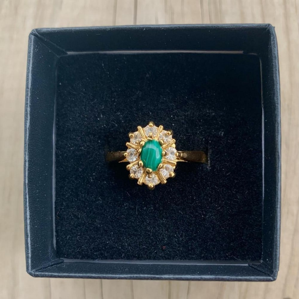 Sophisticated Oval Malachite Ring: Sophisticated Oval Malachite Ring This elegant ring features a richly banded oval malachite stone set at the center of a polished gold-tone band. The vivid green swirls of the malachite create a stri