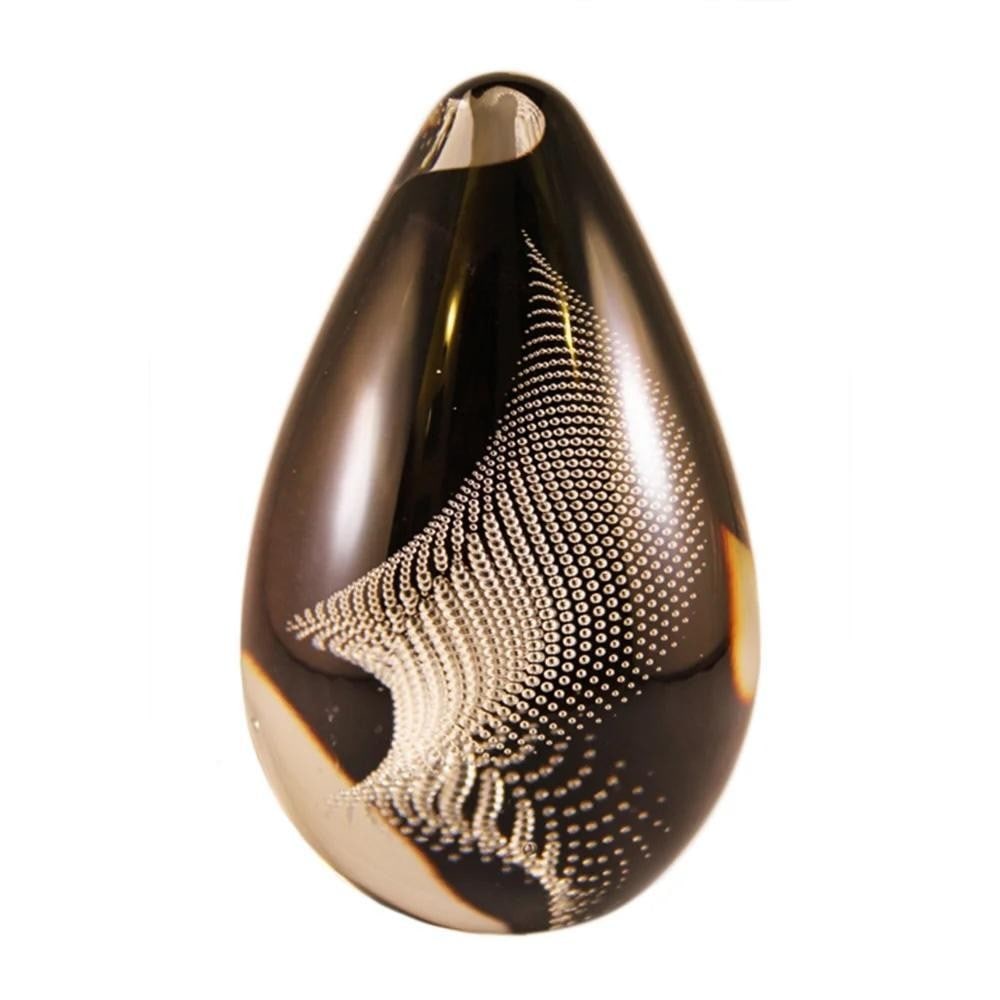 ‘Whirling Dervish’ Glass Paperweight by Remigijus Kriukas: ‘Whirling Dervish’ Glass Paperweight by Remigijus Kriukas Handmade by Remigijus Kriukas, the *Whirling Dervish* paperweight features a dynamic swirl of delicate glass bubbles suspended within cle