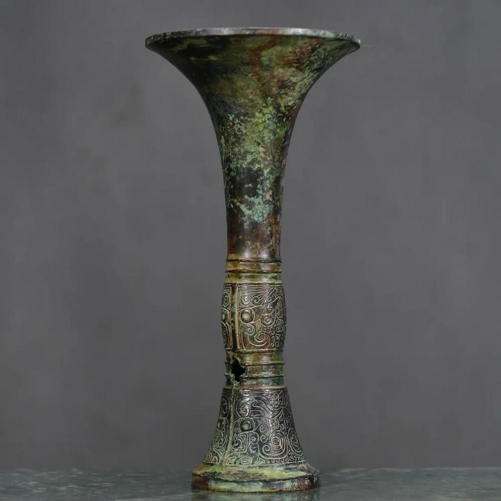 Antique Bronze Blossom Goblet Statue: Antique Bronze Blossom Goblet Statue This rare and beautifully crafted Chinese antique features a hand-made bronze goblet, intricately adorned with delicate floral designs. Symbolizing beauty and abun