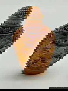 Hand Carved Chinese Cinnabar Style Snuff Bottle: Hand Carved Chinese Cinnabar Style Snuff Bottle This piece features a horse meticulously carved on both sides. The horse, a symbol of strength and vitality in many cultures, adds a touch of historica