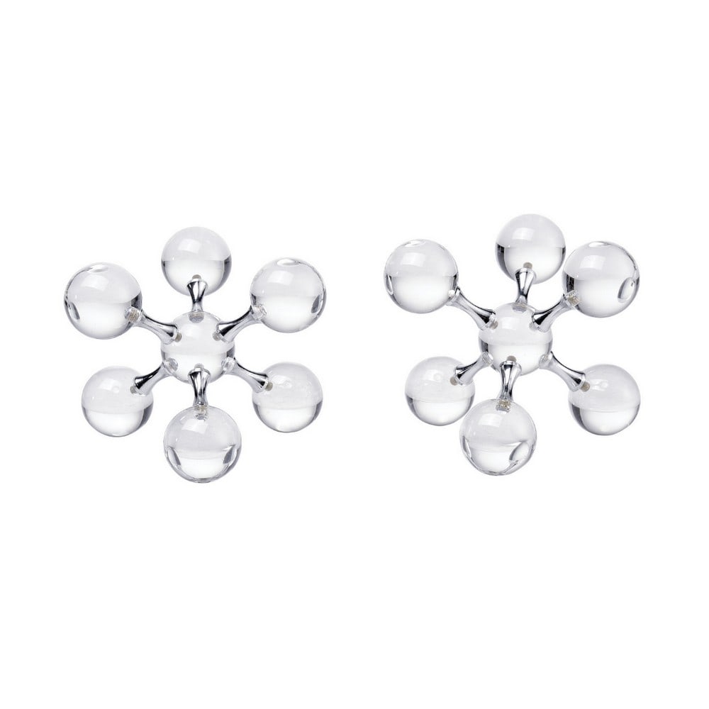 "Clear" Jumble Jacks Collection Bookends: "Clear" Jumble Jacks Collection Bookends Blending classic nostalgia with modern sophistication, these bookends are reimagined in clear crystal and glossy, high-shine chrome. Designed as a set