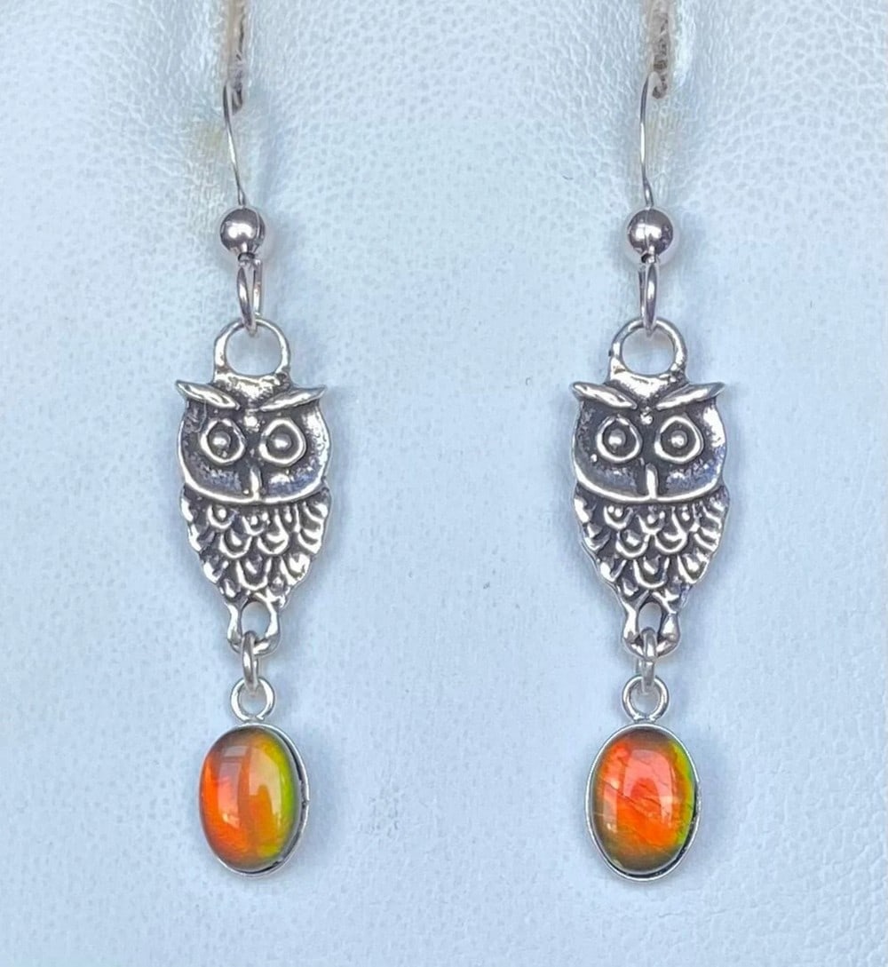 Orange Ammolite Owl Earrings: Orange Ammolite Owl Earrings These Ammolite earrings feature vibrant orange gemstones that shift to green at extreme angles, as shown in the third photo. The 7mm x 5mm medium-dome quartz-capped tripl