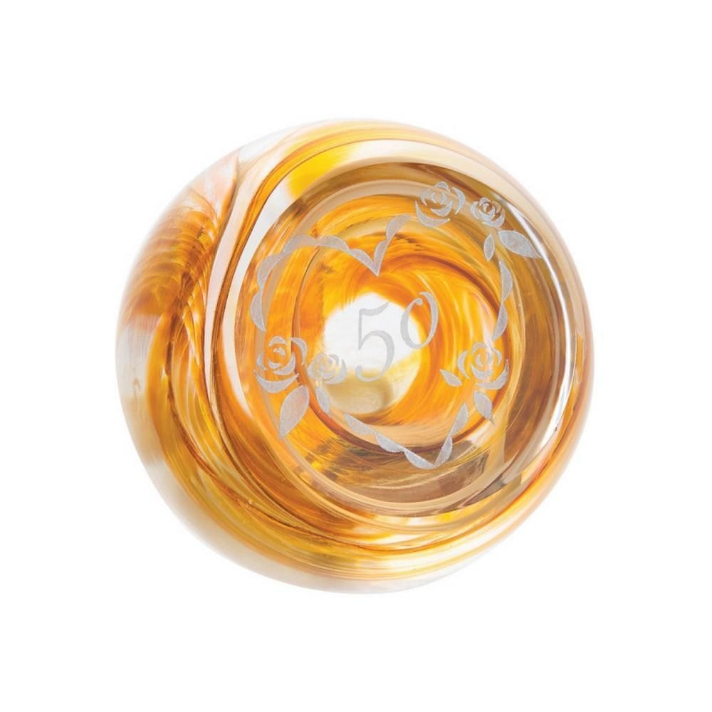 Golden Jubilee Paperweight: Golden Jubilee Paperweight A handcrafted glass paperweight celebrating a 50th milestone. Layers of swirling yellow and amber glass create a sense of joy and festivity, while a subtle heart motif encas