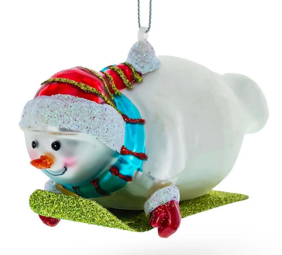 Hand-painted Snowman Riding the Sled Christmas Ornament: Snowman Riding Sled Glass Christmas Ornament When it’s time to decorate the tree, yours will shine with beautiful Christmas ornaments. Ornate designs with shimmering paint and glitter, this glass or