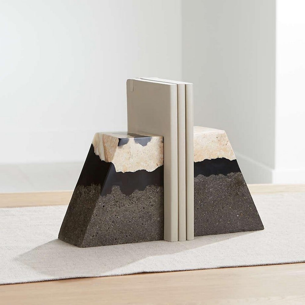 Set of 2 Contemporary Lava Resin Bookends: Set of 2 Contemporary Lava Resin Bookends This exclusive set of two bookends features a captivating combination of limestone, lava stone, and resin. Poured black resin seamlessly integrates with the