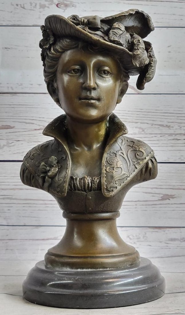Victorian Era Woman In Feathered Hat Bronze Bust Sculpture - 11" x 5": A chic European woman is dressed to impress. She naturally radiates elegance in her daily life. A wonderful headdress adorns her head and is shifted off to the side of her face. The 100% bronze bust s