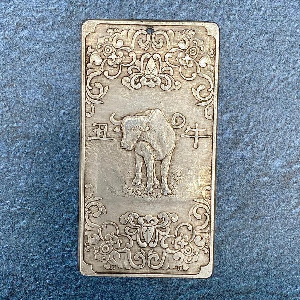 Tibetan Silver Amulet Bar Depicting The Year of the Ox: Tibetan silver amulet bar featuring the Ox, in relation to the year of the Ox in Tibetan astrology. Those born in 1925, 1937, 1949, 1961, 1973, 1985, 1997, 2009, 2021 are born in the year of the Ox.