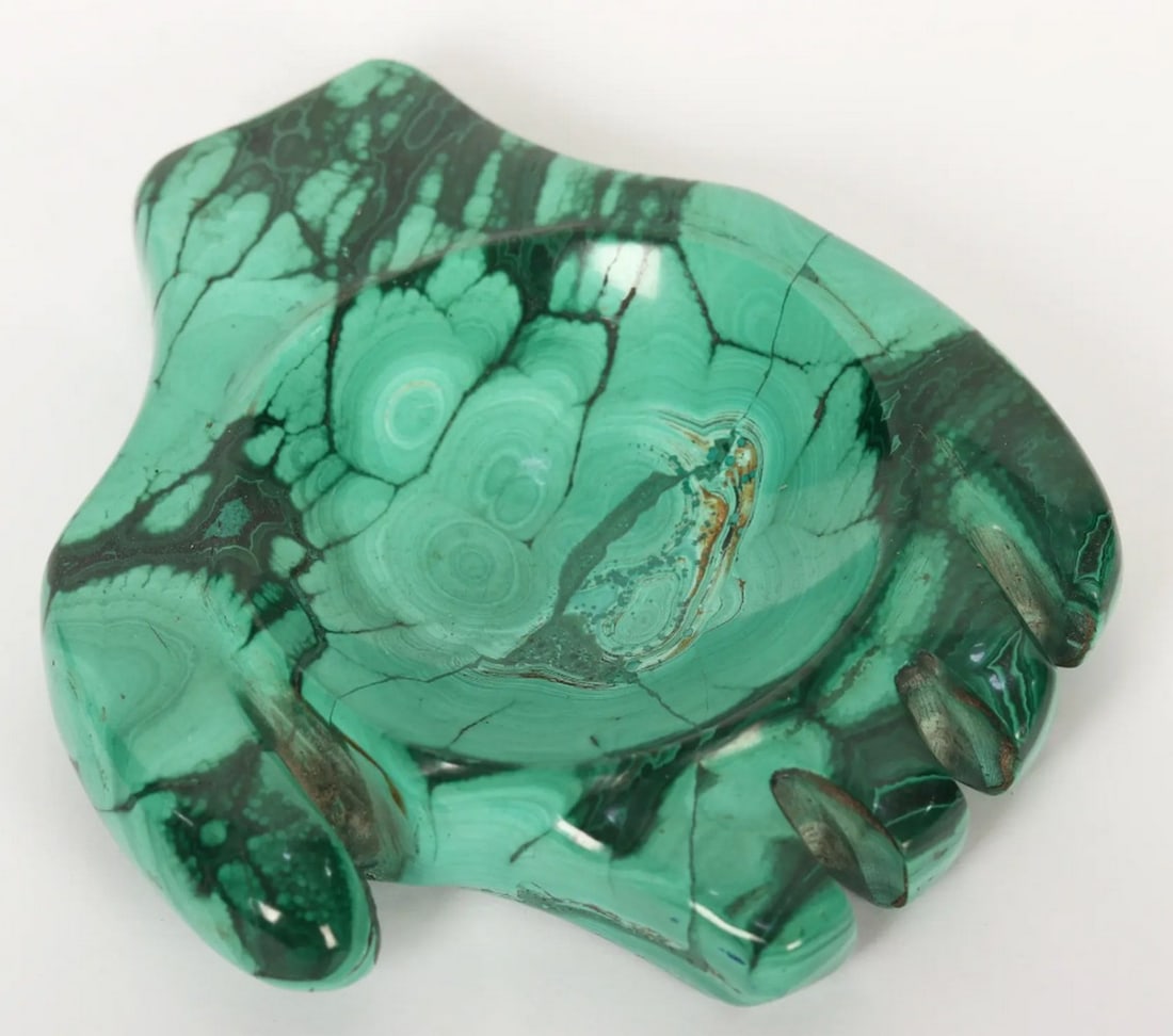 Malachite Hand Design Candle Holder: Malachite Hand Design Candle Holder A unique candle holder crafted from malachite shaped like a hand. Known for its protective and energy-balancing properties, malachite adds a spiritual element to t