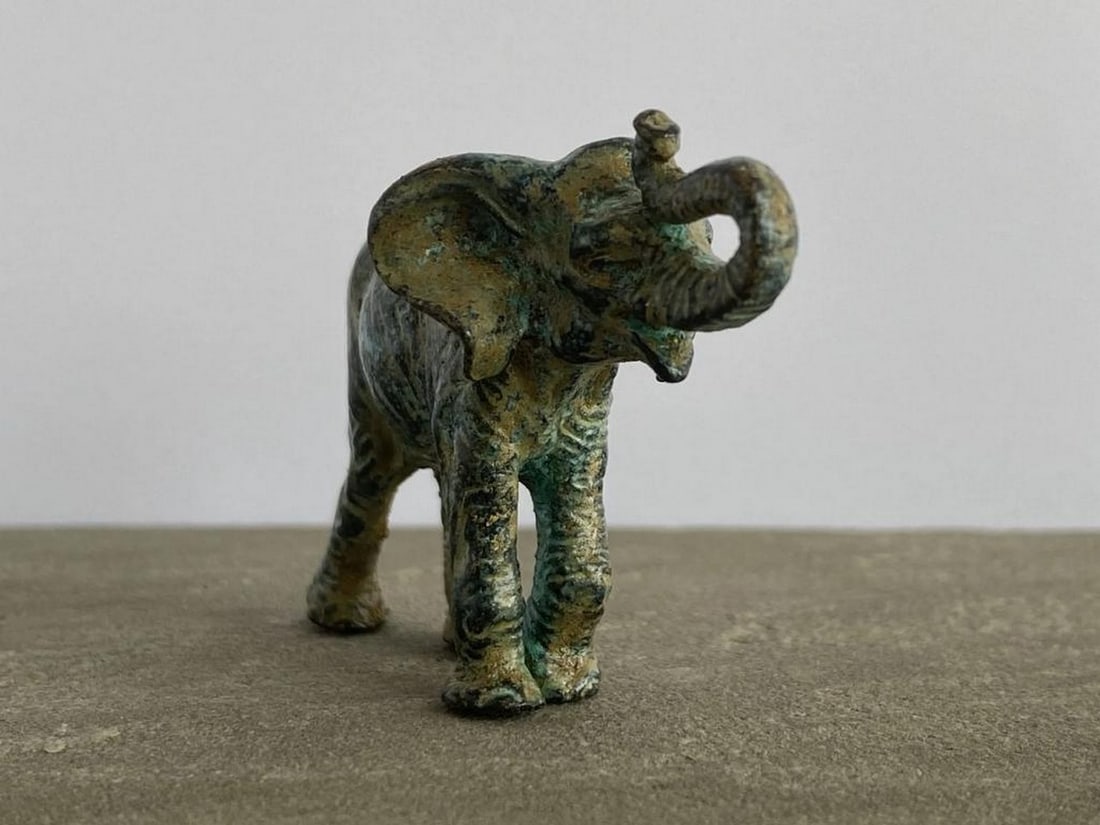 Aged Copper Elephant Statuette - (0.9lbs): Aged Copper Elephant Statuette - (0.9lbs) This charming elephant statuette features distinctive carved patterns that capture the majesty of this beloved animal. Crafted from high-quality copper-zinc