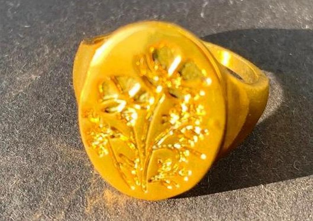 Gold Floral-Engraved Ring: Gold Floral-Engraved Ring A timeless piece that blends elegance with delicate artistry. This gold-coloured ring features a beautifully engraved floral design on the front, adding a subtle touch of