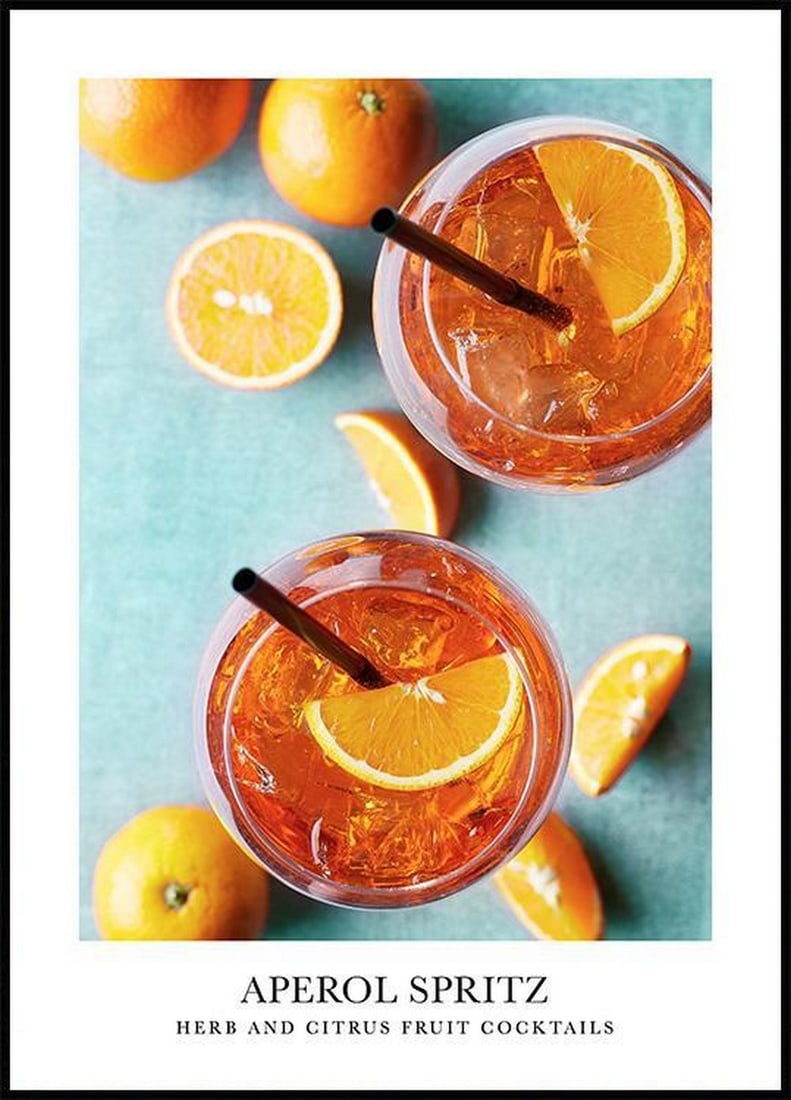 Aperol Spritz Poster: Aperol Spritz Poster Photograph of a delicious Aperol spritz in glasses with straws, accented by oranges on a blue cloth and the text "Herb and grapefruit cocktails". This poster is printed o