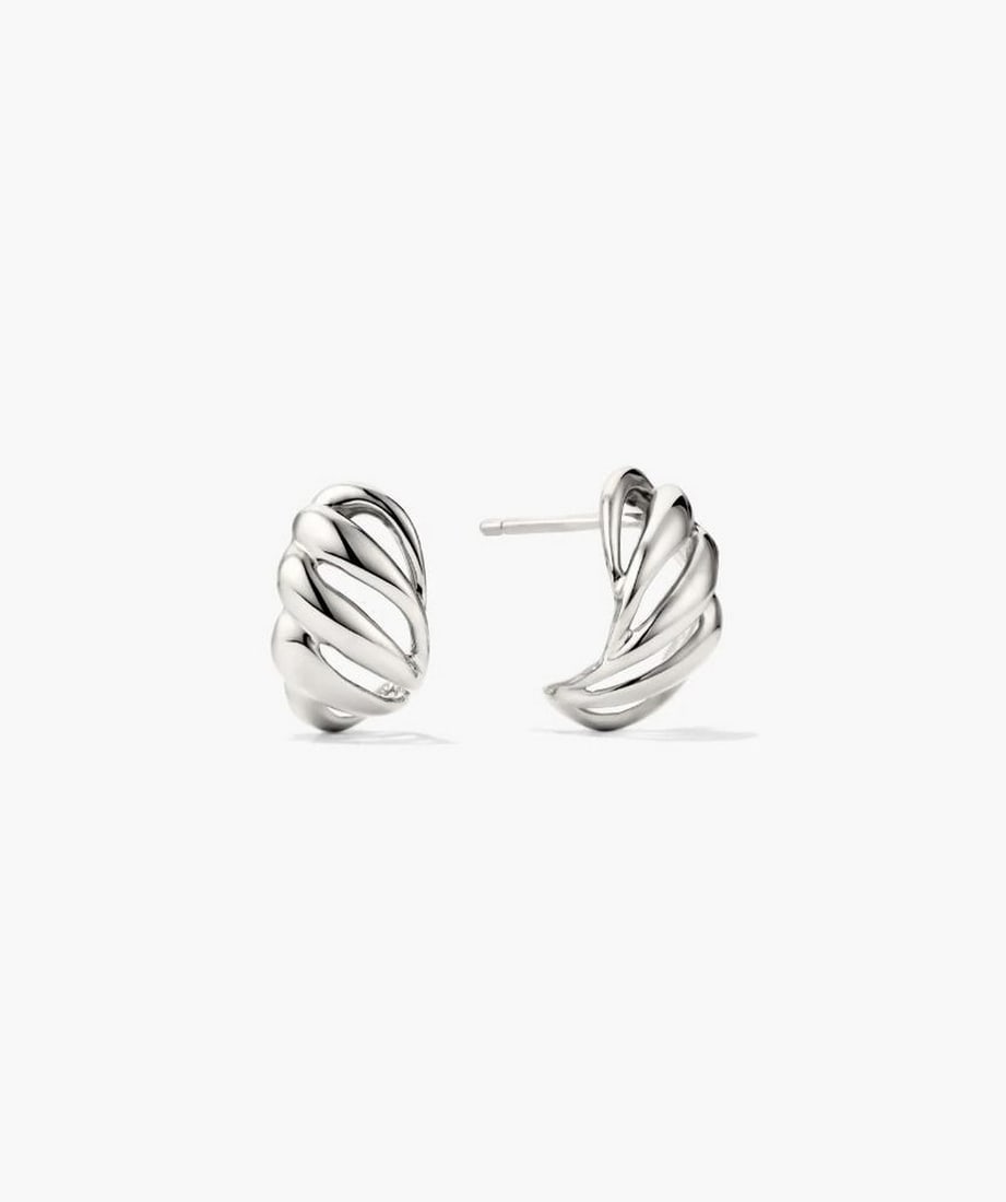Textured Sterling Silver Huggie Earrings: Textured Sterling Silver Huggie Earrings A contemporary twist on a classic design, these huggie earrings feature asymmetrical lines and open spaces for a subtle yet striking look. Crafted from